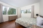 Bedroom 2 offers a queen size bed, adjoining ensuite & incredible lake views.